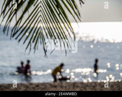 blur image of silhouettes of happy people swimming on the beach Stock Photo
