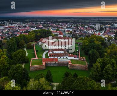 Sarvar, Hungary - Aerial panoramic view of the Castle of Sarvar (Nadasdy castle) with a beautiful dramatic sunrise at background on a summer morning Stock Photo