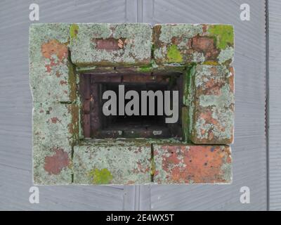 Brick Chimney Top Inspection Clean for Soot Looking From Top Down Chimney on Tin Roof Stock Photo