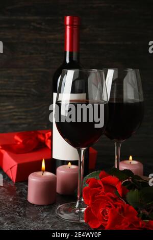 Concept of Valentine's day with roses and wine on black smokey table Stock Photo