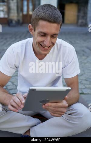 Serious young male executive using digital tablet Stock Photo