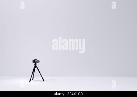 Photo and video tripod with nonexistent DSLR camera on the white backgound Stock Photo