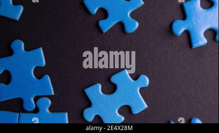 scattered puzzle pieces on colored background Stock Photo