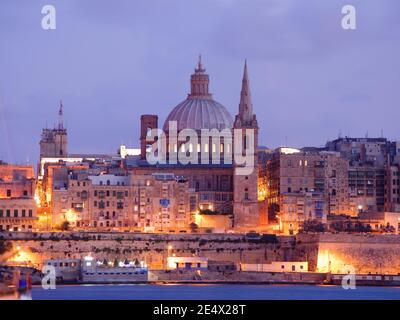 night view of Valletta with the belltower of St. Paul Cathedral and dome of Carmelite Church at the twilight Stock Photo