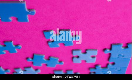 scattered puzzle pieces on colored background Stock Photo