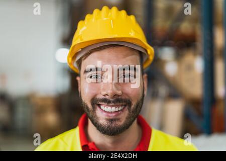 Portrait of happy young man working in delivery warehouse - Logistic and industry concept Stock Photo