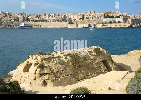 skyline of Valletta from Kalkara, in the foreground the ruins of the old thermal baths, building built with sandstone blocks, Malta Stock Photo