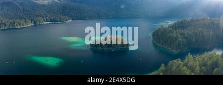 Panoramic aerial view of Eibsee lake island tree by Zugspitze before sunset in Germany Stock Photo