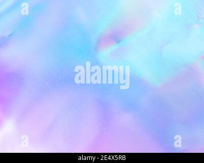Beautiful holographic rainbow abstract background in pastel and neon color design. Real photography shot of holographic foil for creative project - design fashion, cover, book, printing. Copy space Stock Photo