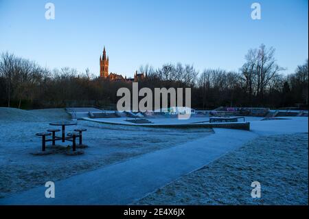 Glasgow, Scotland, UK. 25th Jan, 2021. Pictured: A cold and frosty morning with temperatures overnight dipping to -2C, as the sun rises, the temperature rises only to about  1C in some areas with icing and frost covering the ground. A warm morning glow in the west as the rising sun illuminates the city, showing Kelvingrove Park and Glasgow's west end area. Credit: Colin Fisher/Alamy Live News Stock Photo