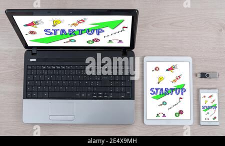 Startup concept shown on different information technology devices Stock Photo