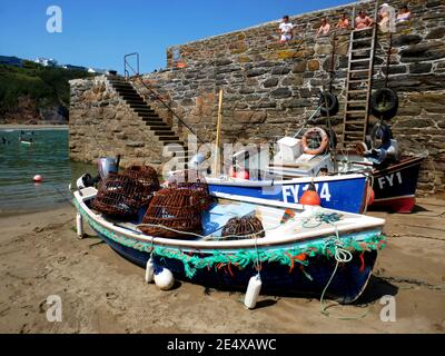 Low tide in the harbour at Gorran Haven, Cornwall. Note the traditional wiithy crab pots. Stock Photo