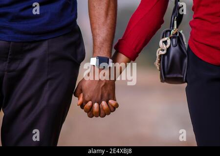young beautiful couple holding hands and having a love stroll together Stock Photo