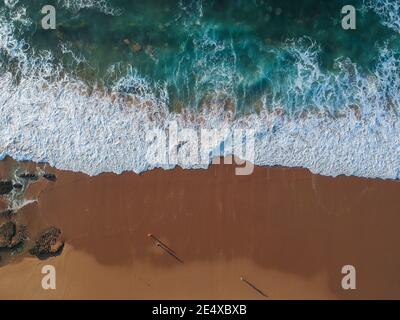 Aerial view of sea waves and sandy beach Stock Photo