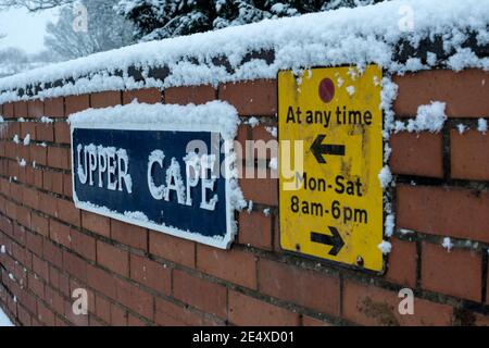 Upper Cape street sign and parking restrictions in snowy weather, Warwick, Warwickshire, UK Stock Photo