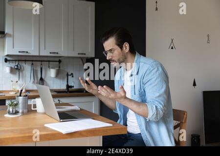 Angry male working from home losing data at pc crash Stock Photo