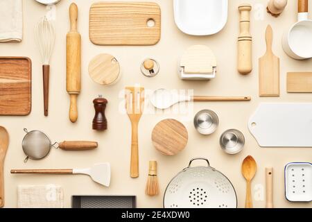 Flat lay of assorted wooden and ceramic utensils and containers placed on beige background Stock Photo