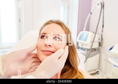 Woman as a patient during a consultation with a dermatologist about cosmetic surgery Stock Photo