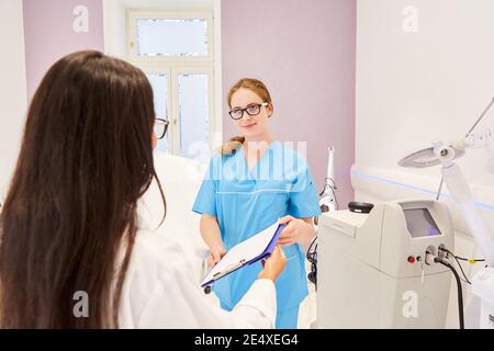 The doctor and the OR nurse work together in the beauty clinic or in the doctor's office Stock Photo