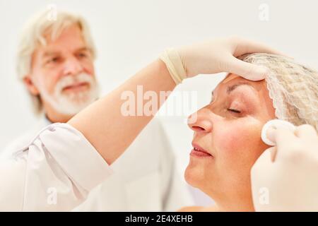 Elderly woman having an inspection after an eyelid correction in the beauty clinic Stock Photo