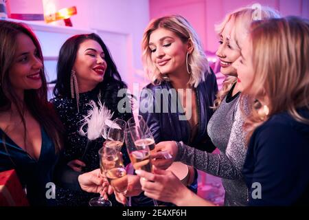 Joyous ladies clinking their glasses at the party Stock Photo