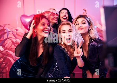 Cheerful ladies taking selfies at the bachelorette party Stock Photo