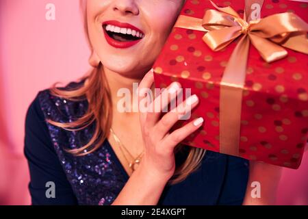 Joyous young female holding a present box Stock Photo