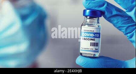 scientist with coronavirus vaccine bottle in hand. copy space Stock Photo