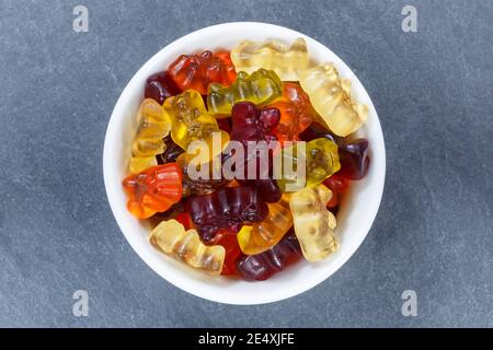 Gummy bears sweets gummybears from above bowl on a slate Stock Photo