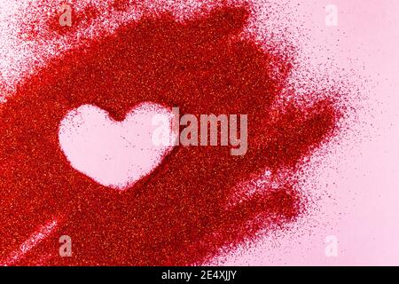 Valentine's Day concept. Heart shaped painted by on red glitter. Stock Photo