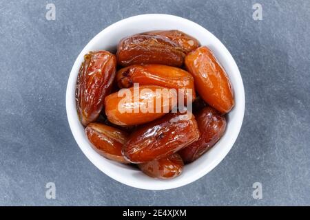 Dates fruit date from above bowl on a slate Stock Photo