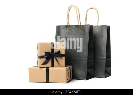 Gift boxes and paper shopping bags isolated on white, gift boxes with bags for holiday gift shopping, a gift set cutout Stock Photo