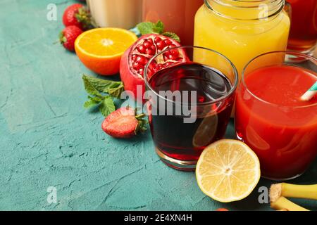Concept of glasses and jars with different juices on green background, a colorful lineup of fresh juices Stock Photo