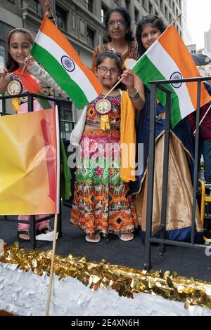 3 generations of Indian Americans with flags pose on a float at the 2018 India Day Parade in Manhattan, New York City. Stock Photo