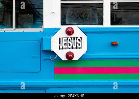 The name Jesus written on the back fo a very colorful bus 'stop' sign.. As seen in Flushing, New York City. Stock Photo