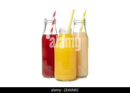 Bottles with different juices isolated on white background, a set of fresh fruit juices in glass bottles for healthy drink Stock Photo