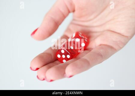 On hand are red dice with white marks Stock Photo