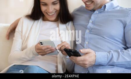 Close up smiling woman and man using phones, sharing news Stock Photo