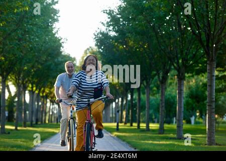 Happy emotional couple on bikes. Stock Photo