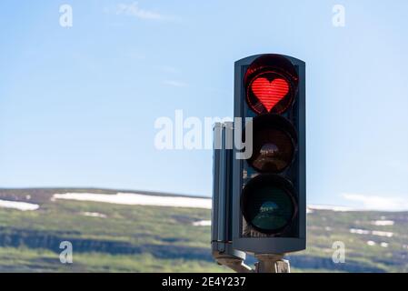 Traffic lights with a red heart-shaped signal