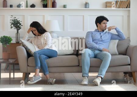 Unhappy young woman and man not talking after quarrel Stock Photo