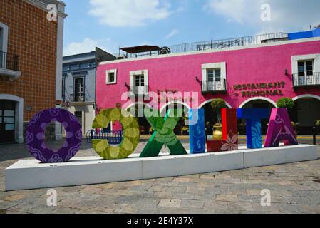 Panoramic view of the Plaza de Armas (Zócalo) the main square with the Colonial buildings and the colorful letters sign of the town in Atlixco Mexico. Stock Photo