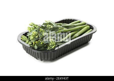 Plastic container with broccolini isolated on white background Stock Photo