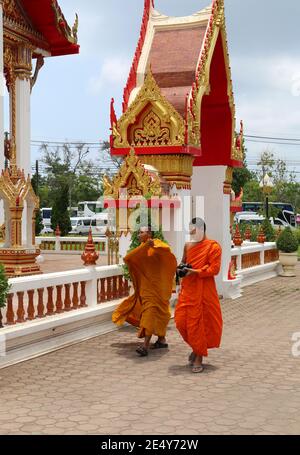 PHUKET,THAILAND-APRIL 7:Buddhist Monks walking and taking photos with their cameras at Chalong Temple.April 7,2016 in Phuket,Thailand. Stock Photo