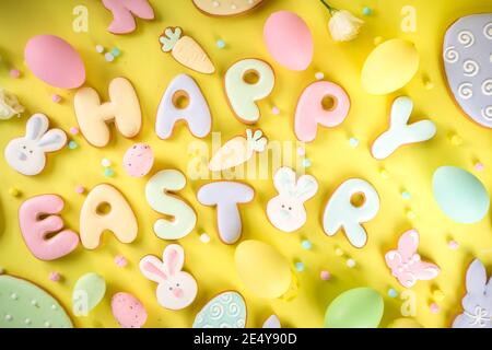 Easter cookie background. Colorful sugar glazed easter cookies, with letter Happy Easter and various Easter symbols and decor. Traditional Easter swee Stock Photo