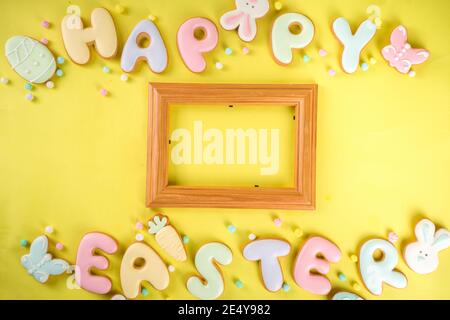 Easter cookie background. Colorful sugar glazed easter cookies, with letter Happy Easter and various Easter symbols and decor. Traditional Easter swee Stock Photo