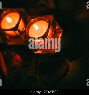 two burning candles on a dark background Stock Photo