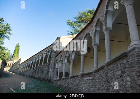 The ascent of the hill leading to the castle of Udine, Italy, in the late afternoon light Stock Photo