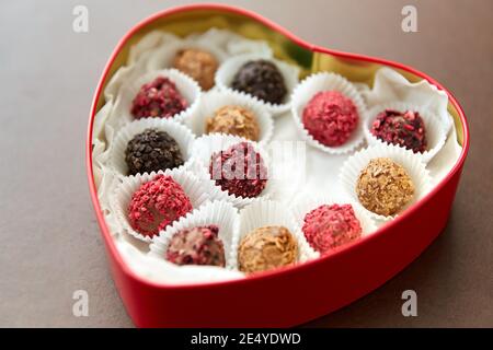 candies in red heart shaped chocolate box Stock Photo