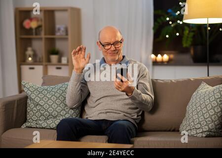 old man with smartphone having video call at home Stock Photo